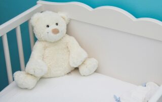 Teddy bear in crib